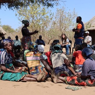 USAID and WFP representatives interacting with the affected community of Malassa, Macate district, Manica province