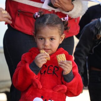 A girl eating biscuits