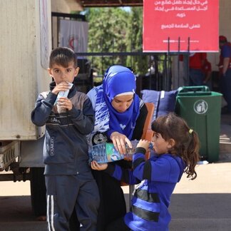 Thousands of Lebanese and Syrians flee into war-torn Syria. WFP is providing fortified date bars for the children as the entry procedures are taking long time approximately 2 hours minimum due to the huge numbers arriving at the border