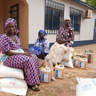 Women with food assistance provided by WFP. Photo: WFP/Mamadou Jallow