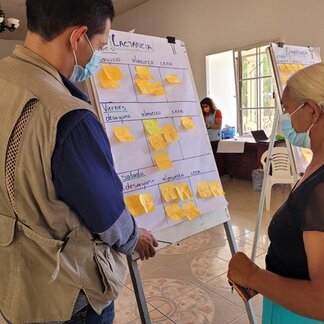 A WFP employee guides a local woman during a training on proper nutrition and healthy diets to prevent malnutrition among rural communities. Photo: © WFP/Hetze Tosta