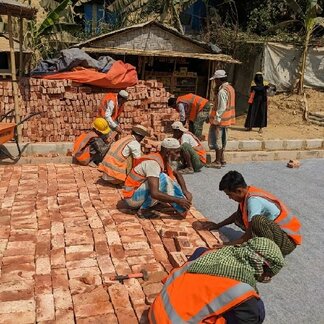 Beneficiaries in the Rohingya refugee camp Kutupalong, Cox’s Bazar building roads through the SMEP Project Link Road and receive cash for work. Photo: WFP/Lena von Zabern
