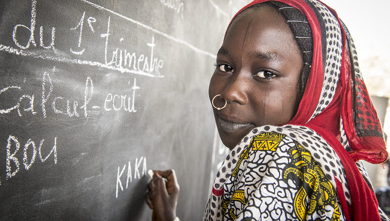 Kaka Marabou writing her name on the school blackboard in Yakoua, Lake Chad. Refugees, displaced people and other poor communities in the Lake Chad basin are dependent on humanitarian assistance for survival and access to basic education is also limited. WFP/Giulio d'Adamo