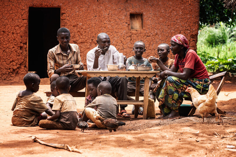 Jean Nkeramihigo and Francine Kanyana eat lunch together with their son and grandchildren in Kirundo Province, Burundi