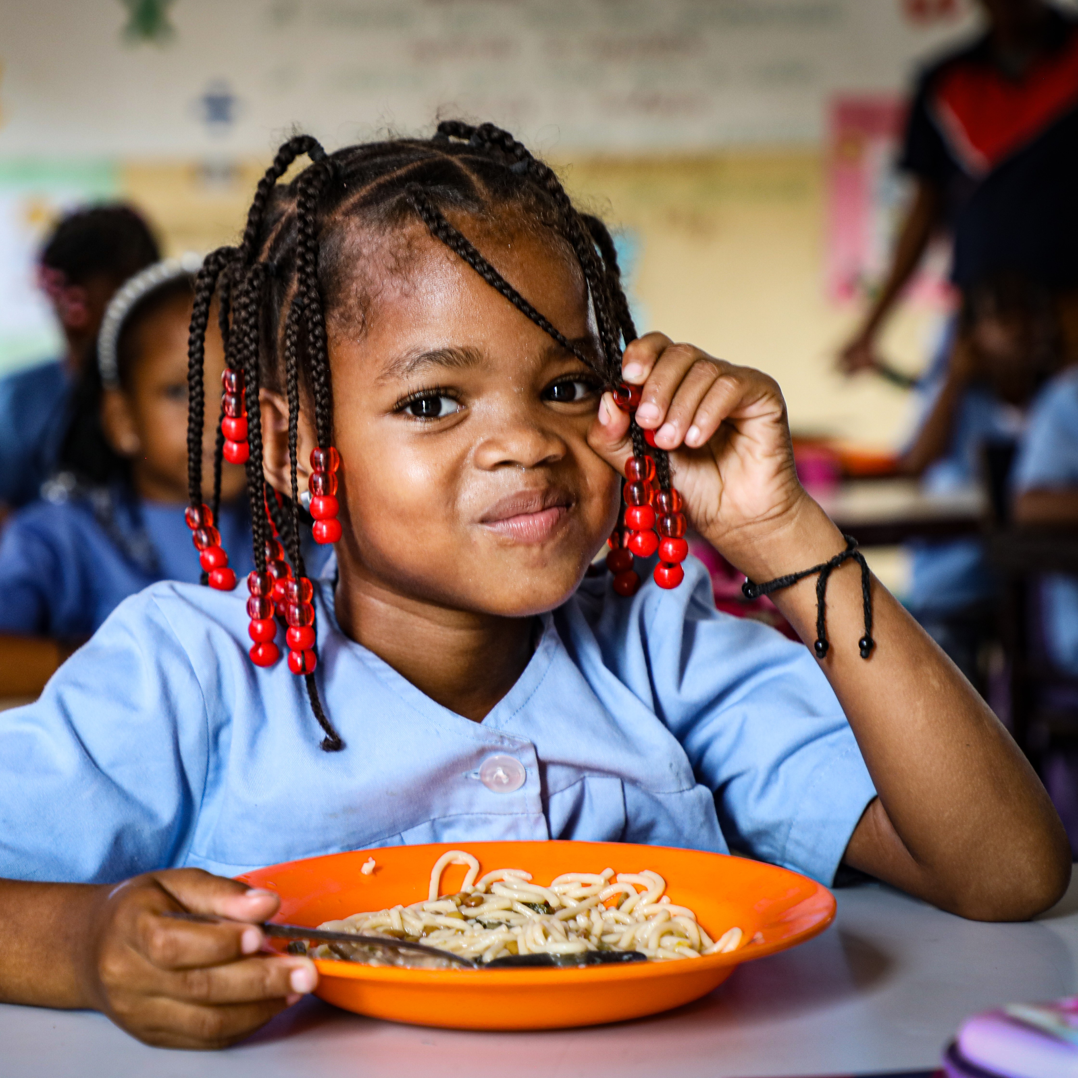 A learner from Eugenio Tavares Primary School in Praia enjoys a hot meal provided by the National School Feeding Programme in Cape Verde.