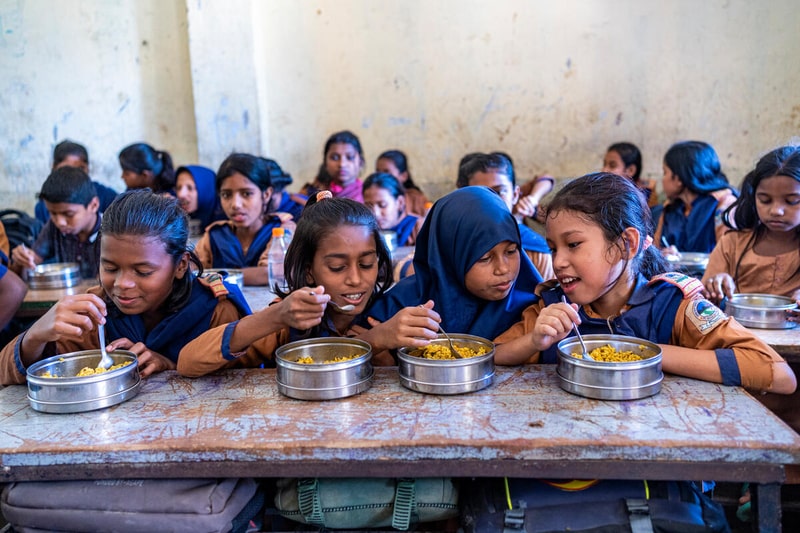 Yonchi Marma (10) is having vegetable Khichuri. © WFP/Sayed Asif Mahmud