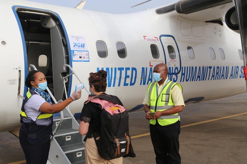 Pre-boarding temperature control of passengers in accordance with the Covid 19 pandemic barrier measures of UNHAS Niger passengers with humanitarian staff to reach vulnerable populations in Niamey. © WFP/Mariama Ali Souley