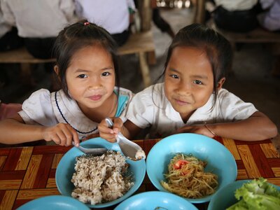 Photo: WFP/Vilakhone Sipaseuth Two girls eating healthy school meal