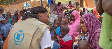 Photo: WFP/Agron Dragaj WFP staff addressing a woman